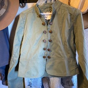 Olive green canvas coat. Zipper front, faux button detail. Light weight.